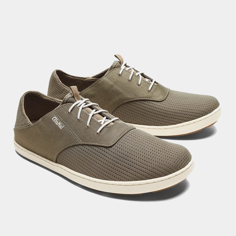 OluKai Nohea Moku shoes in olive green with breathable mesh upper, lightweight construction, and white sole, angled side view.