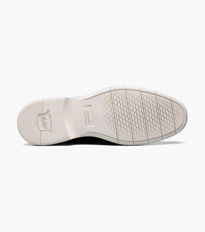 Florsheim Norwalk Plain Toe Oxford shoe outsole in white showing textured grip pattern and branding detail.