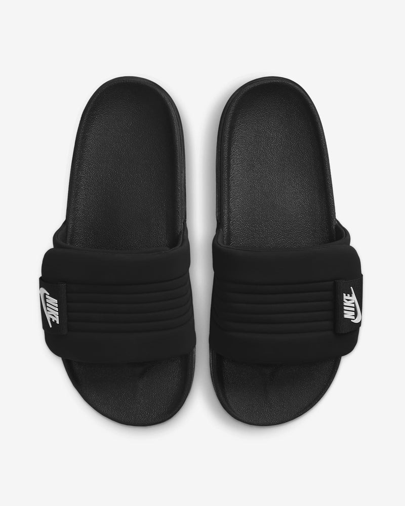 Nike Offcourt Adjustable Slide sandals in black with padded strap and white Nike logo patch, top view.