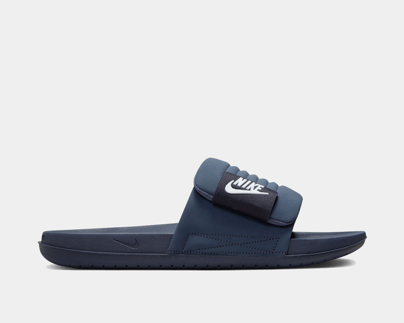 Nike Offcourt Adjustable Slide sandals in navy blue with padded strap and white logo detailing on side view.