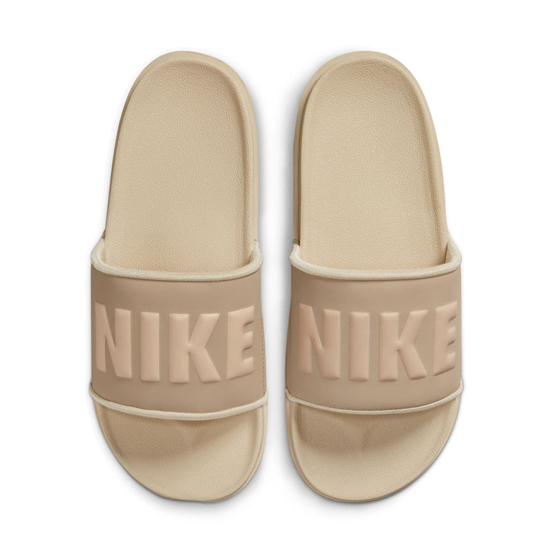 Nike Offcourt Slide sandals in beige with textured footbed and bold Nike logo on wide strap, top view.
