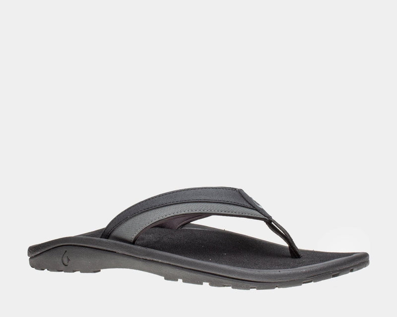 OluKai Ohana KOA sandals in black with water-resistant straps, a cushioned footbed, and durable rubber outsole, side view.