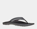 OluKai Ohana KOA sandals in black with water-resistant straps, a cushioned footbed, and durable rubber outsole, side view.