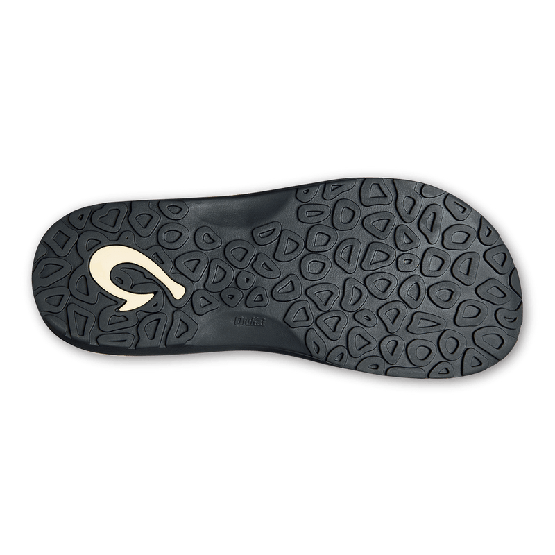 OluKai Ohana Pa'i sandal outsole in black with textured pod design and embossed logo offering grip and durability.