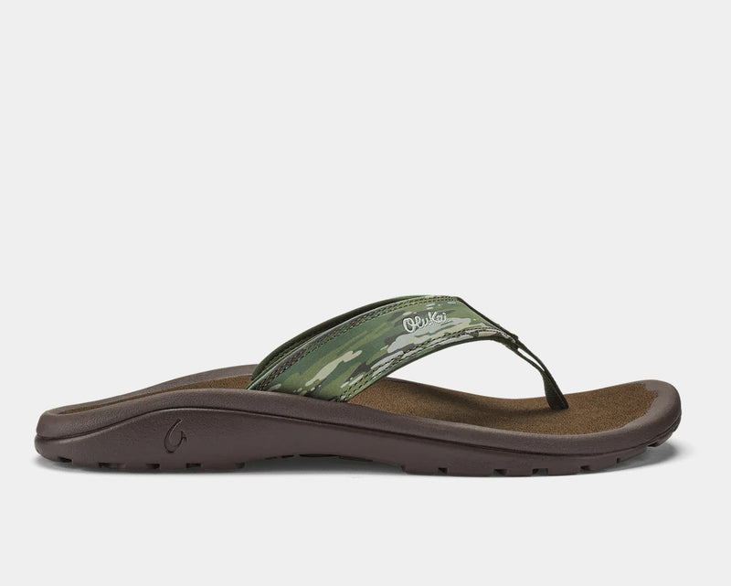 OluKai Ohana Pa'i sandals with a green camouflage strap and brown cushioned footbed, side view.