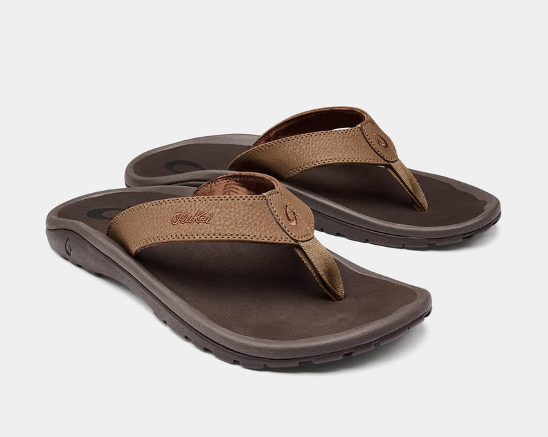 OluKai Ohana sandals in brown with synthetic leather straps and durable rubber outsole, angled side view.