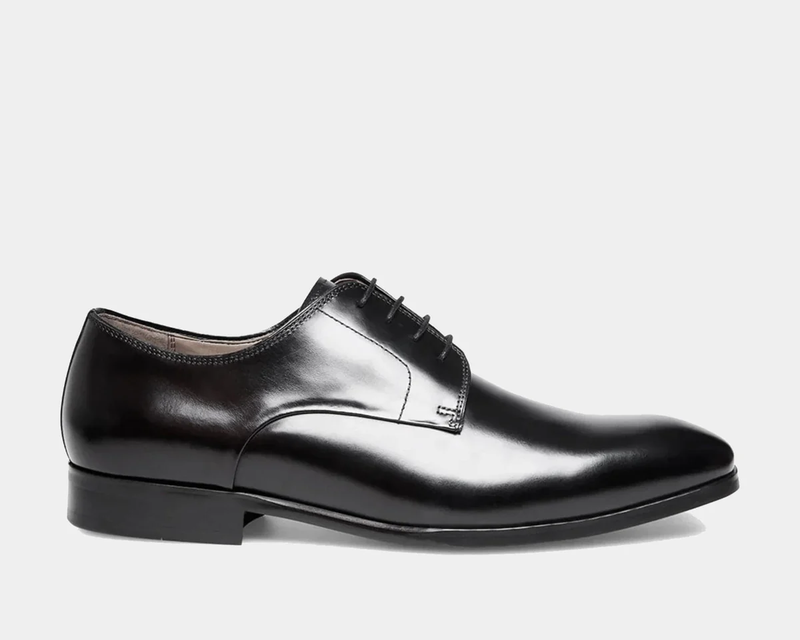 Steve Madden Parsens Leather Oxford shoes in sleek black leather with closed lacing and almond toe design, side view.