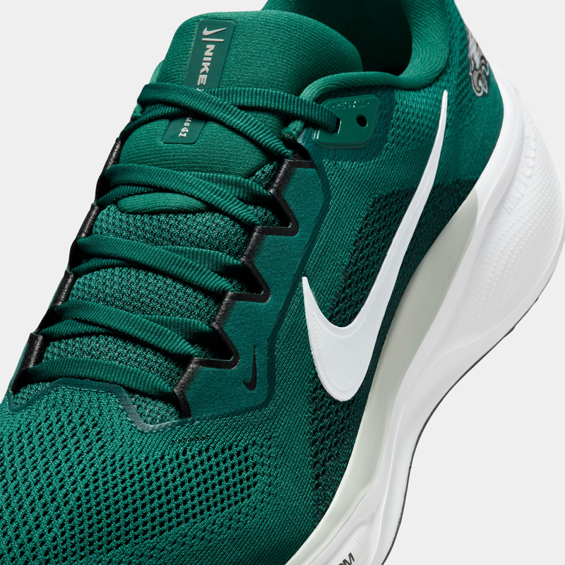 Nike Philadelphia Eagles Pegasus 41 running shoes in deep green with white accents, breathable mesh upper, and visible swoosh logo, angled front view.