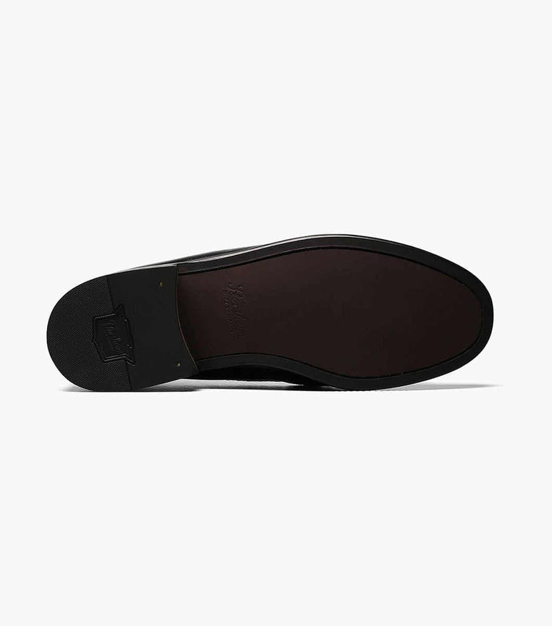 Florsheim Pisa dress shoe sole view featuring a black rubber heel and brown leather outsole with embossed branding.