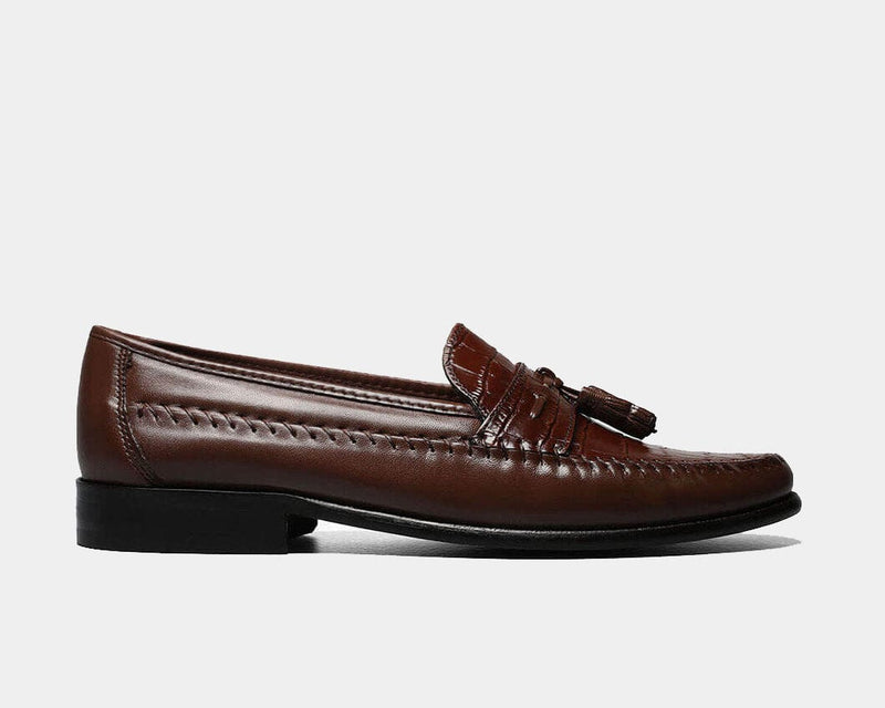 Florsheim Pisa loafers in dark brown leather with moc toe stitching and tassel details, side view.