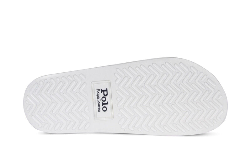 Polo Ralph Lauren Polo Signature Slide sole with textured herringbone pattern in white rubber, bottom view.