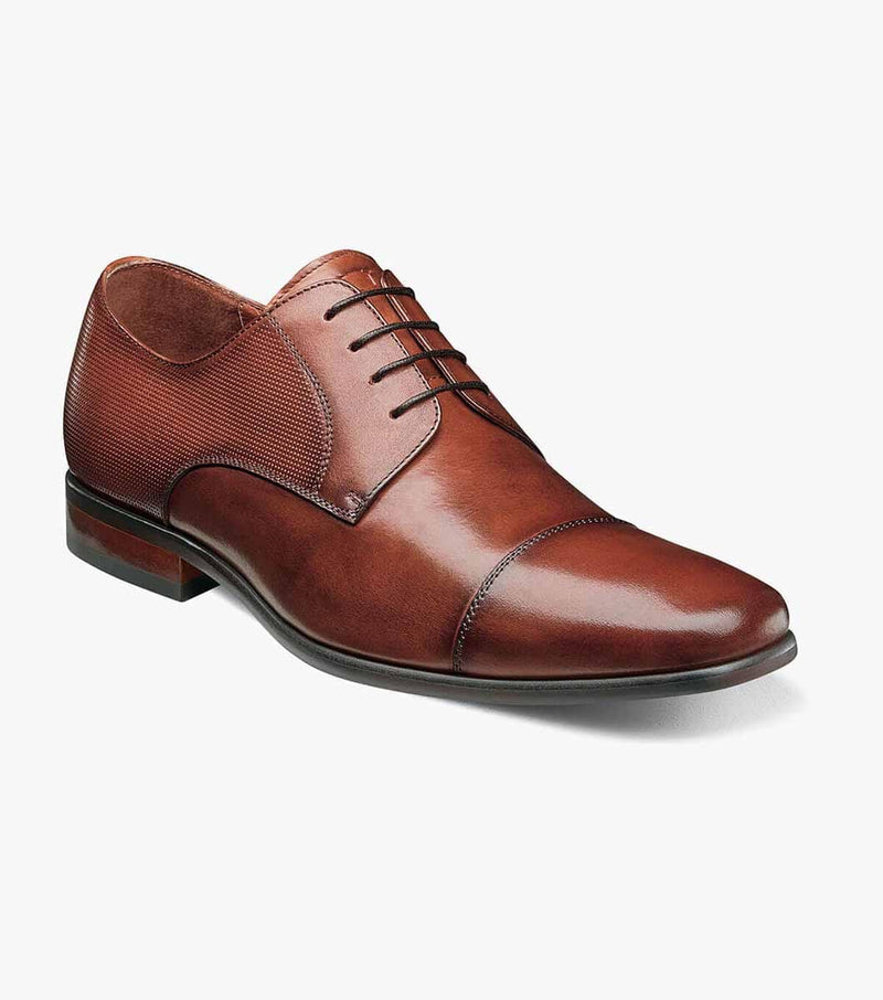 Florsheim Postino Cap Toe Oxford dress shoes in polished brown leather with textured side panels and cap toe design, angled side view.