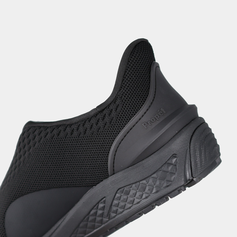 Propét One Velocity Slip-On shoe in black with breathable mesh upper, textured outsole, and heel detailing, back view.