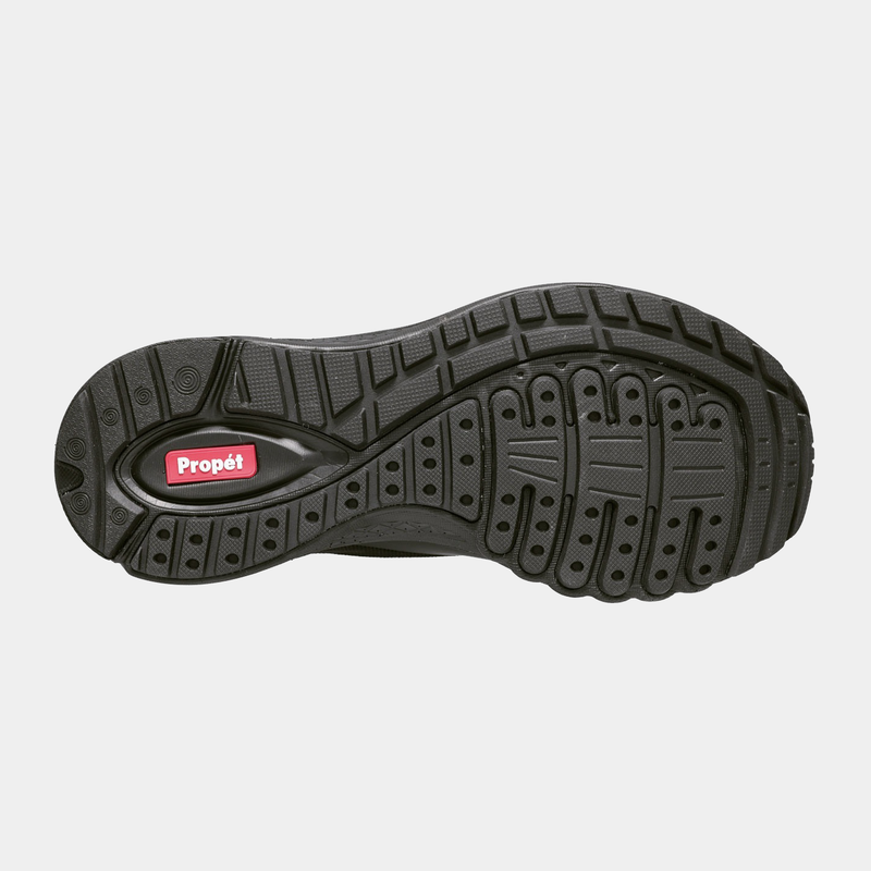 Propét One Velocity Slip-On shoe outsole with black rubber tread pattern and red Propét logo detailing, sole/bottom view.