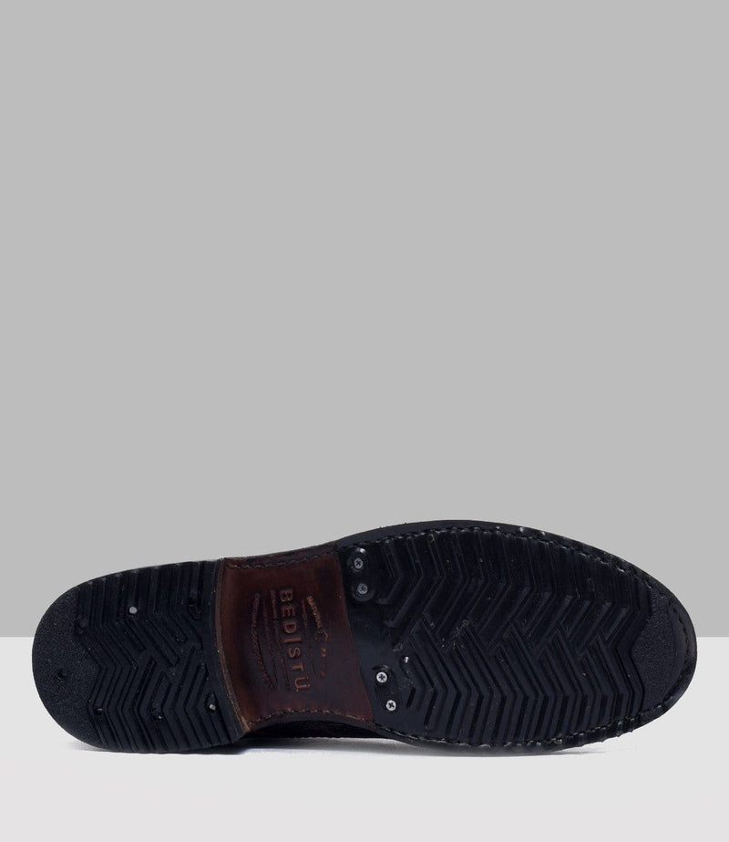 Bed Stu Protege shoe sole featuring dark textured rubber with zigzag traction pattern and leather accent with branding.