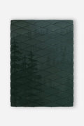 Nomadix Puffer Blanket in dark green with quilted design and subtle tree pattern, front view.