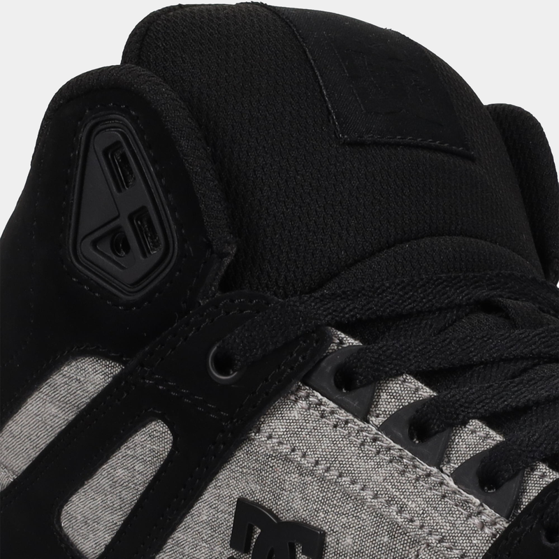 DC Footwear Pure High Top WC sneakers with black laces, black padded tongue, and gray textured panels, close-up view.