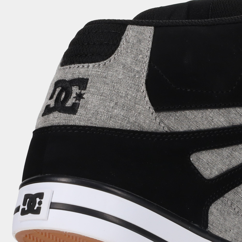 DC Footwear Pure High Top WC sneakers with black and gray textile upper, stitched details, and white midsole, side view.