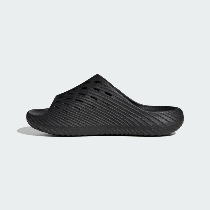 Adidas PURECHILL Slides in black with textured upper and perforations, side view.