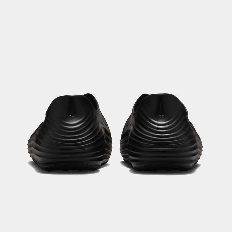 Nike ReactX Rejuven8 slip-on shoes in black with ribbed textured design and rounded heel, back view