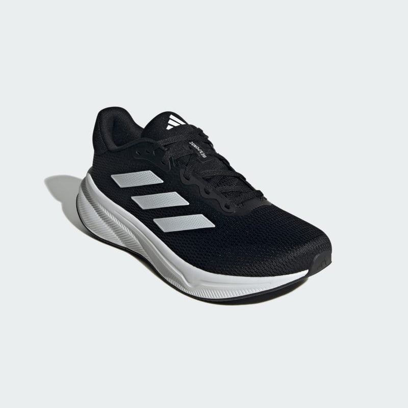 Adidas Response running shoes in black mesh with white sole and three-stripe design, angled front view