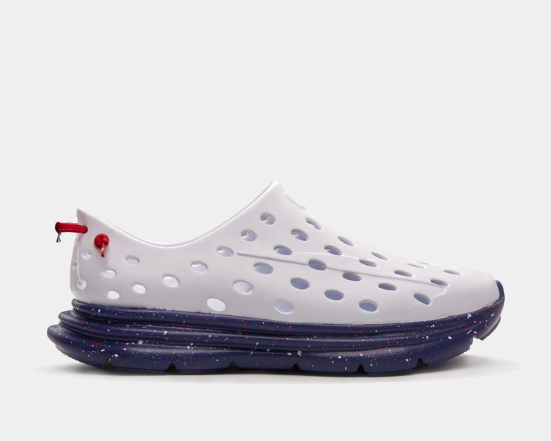 Kane Revive recovery shoes in white with perforated upper and navy blue sole featuring red speckle design, side view.
