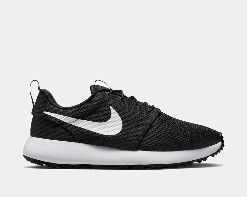 Nike Roshe Golf Next Nature shoes in black with white swoosh, breathable mesh upper and spikeless outsole, side view.