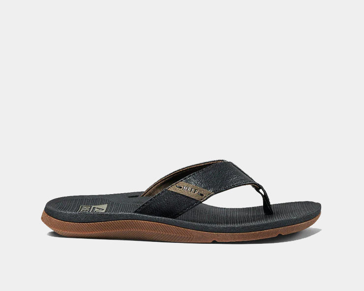 Reef Santa Anna sandals in black with textured footbed and brown outsole, side view.