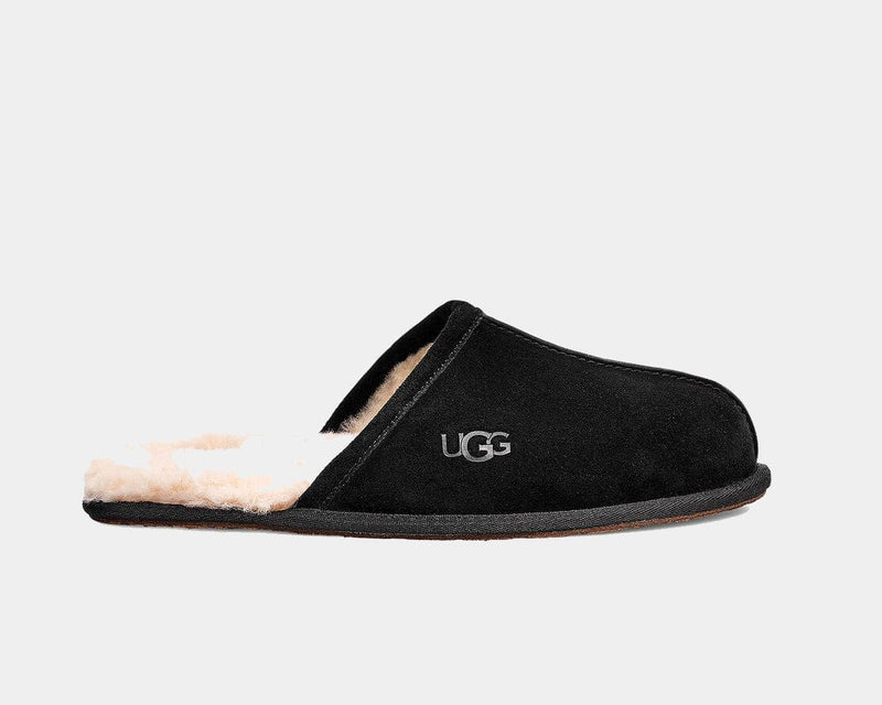 UGG Scuff slippers in black soft suede with plush shearling lining and embossed logo detailing, side view.