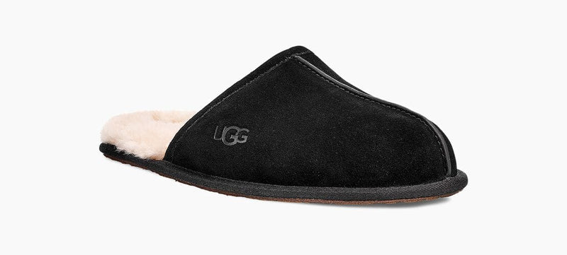 UGG Scuff slippers in black with a suede upper, plush shearling lining, and embossed logo, side view showing slip-on design.