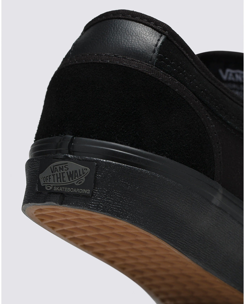 Vans Skate Chukka Low skateboarding shoes back view showing black suede upper, padded heel counter, and gum waffle outsole.