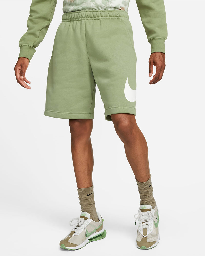 Nike Sportswear Club Shorts in light green with a white Nike swoosh logo on the left leg, shown in front view.
