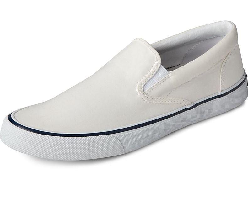 Sperry Striper II Slip On Sneakers in off-white featuring a canvas upper, elastic side panels, and textured white rubber sole, angled side view.