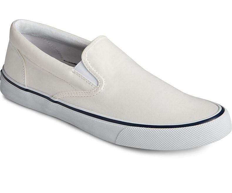 Sperry Striper II Slip On Sneakers in white with canvas upper and rubber outsole, side view showing slip-on design.