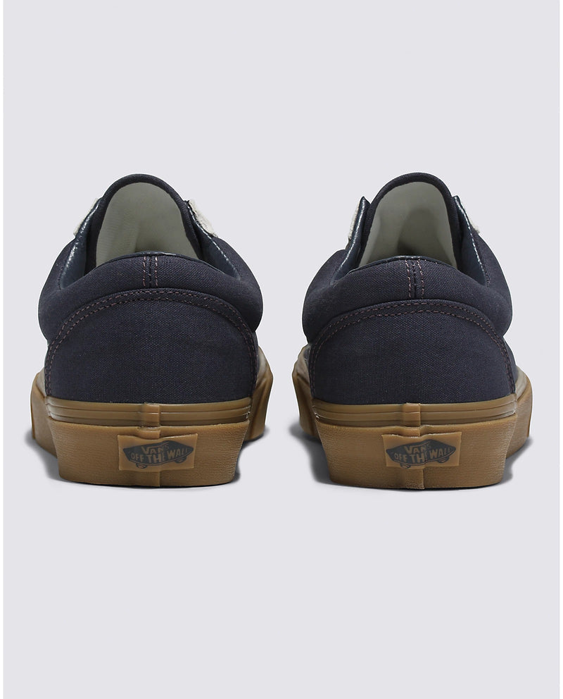 Vans Style 36 sneakers back view showing navy canvas upper, contrast stitching, and gum rubber soles with logo detail.