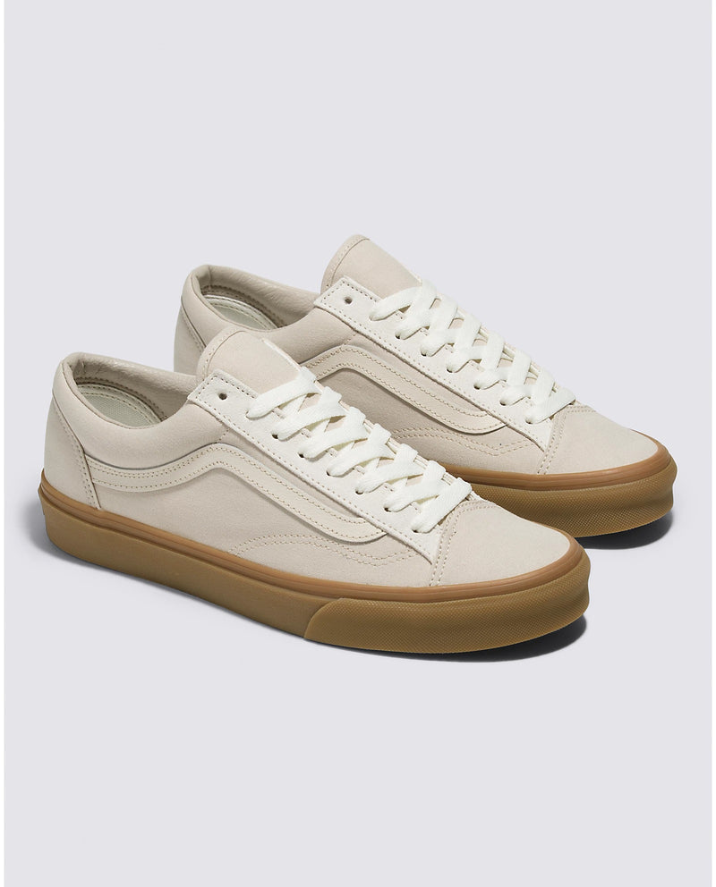 Vans Style 36 sneakers in beige canvas with gum rubber sole, white laces, and signature side stripe, angled front view.