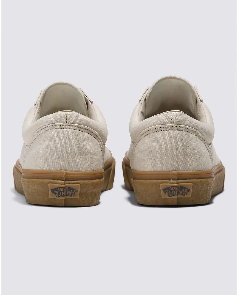 Vans Style 36 shoes in beige canvas with gum rubber outsole featuring "Off The Wall" branding, back view.