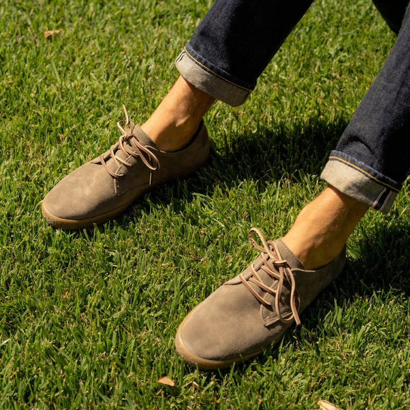 SeaVees Sun-Tans Buck shoes in light brown suede with lace-up closure, worn outdoors on grass.