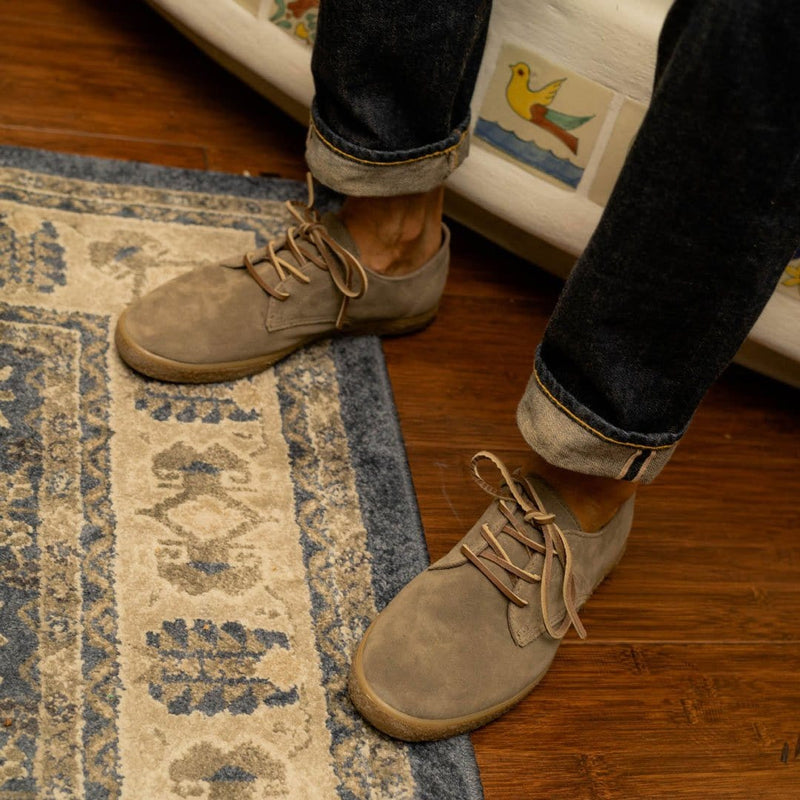 "SeaVees Sun-Tans Buck shoes in light tan suede with lace-up design and rubber outsole, worn indoors on wooden floor and rug"