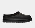UGG Tasman Leather Slipper in black with embossed logo and woven collar detail, side view.