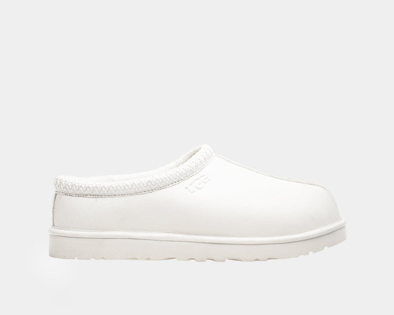 UGG Tasman Leather Slipper in white with embossed logo, textured collar detail, and a durable sole, side view.