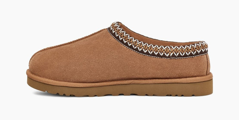 UGG Tasman Slipper in chestnut brown suede with embroidered trim and a durable outsole, side view.