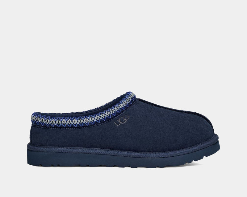 UGG Tasman Slipper in navy blue suede with embroidered trim and Treadlite sole, side view.