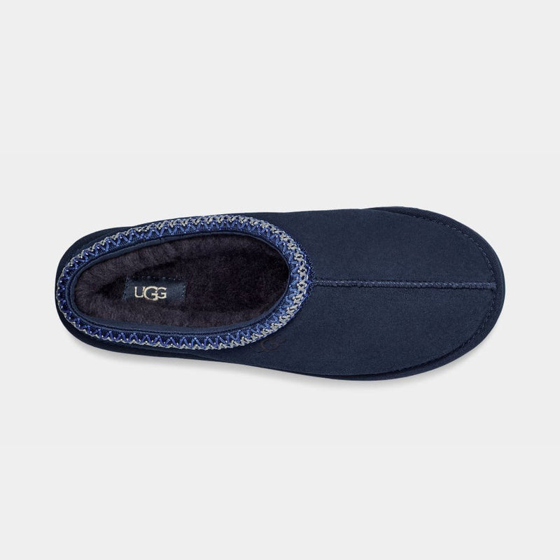 UGG Tasman Slipper in navy blue with plush lining and decorative braided collar, top view.