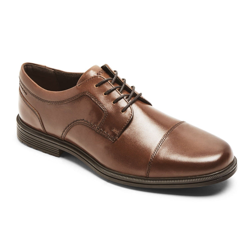 Rockport Taylor Cap Toe dress shoes in brown leather with stitched detailing and cap toe design, side angle view.