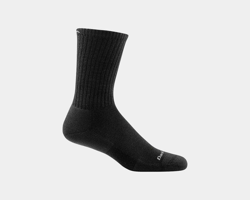 Darn Tough The Standard Crew Light Cushion socks in black with ribbed upper and light cushioning, side view.