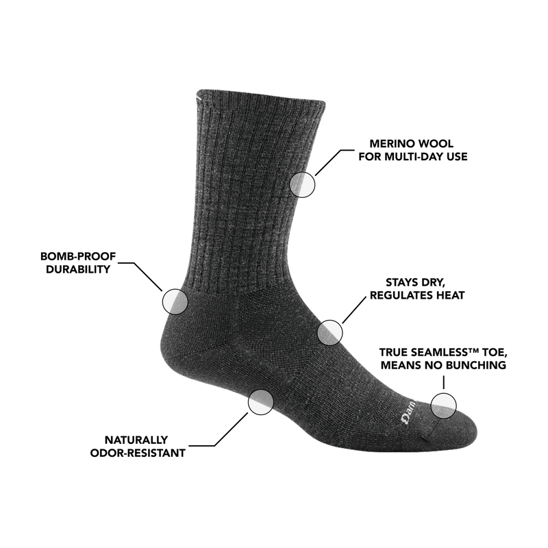 Darn Tough The Standard Crew Light Cushion socks in charcoal gray with ribbed cuff and light cushioning, side view.
