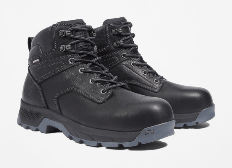 Timberland Pro Titan EV 6" Waterproof Composite Toe Boots in black leather with gray rugged outsoles and reinforced stitching, angled front view.