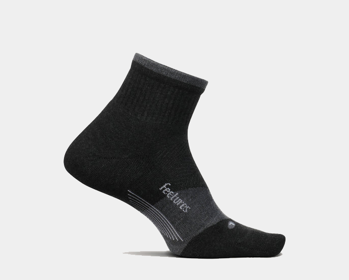 Feetures Trail Max Cushion Quarter Sock in black and gray with arch support and reinforced cushioning, side view.