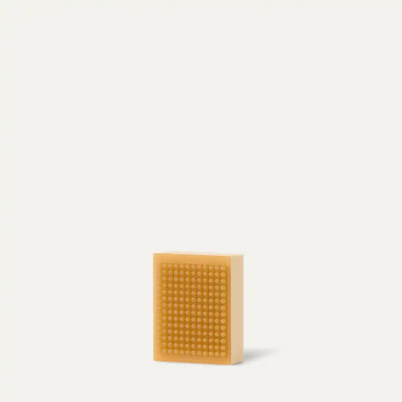 UGG Care Kit cleaning brush with a textured rubber bristle pad in light tan, front view.